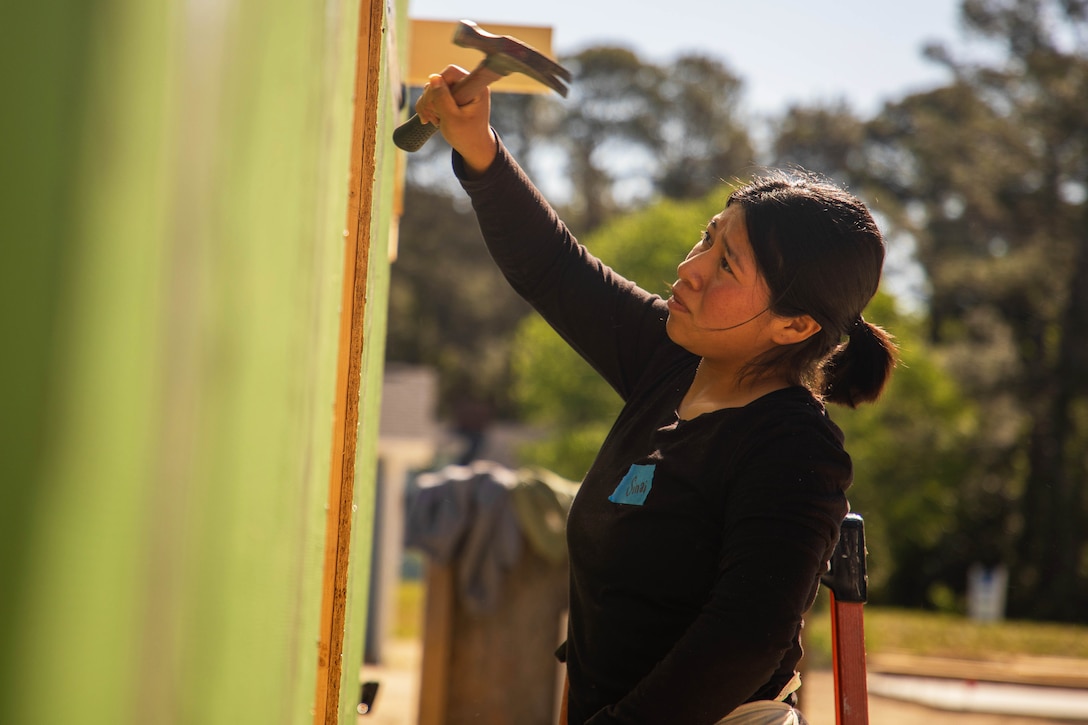 Marine Corps Pfc. Sinai Garcia-Bello does volunteer work with Habitat for Humanity in Wilmington, N.C., April 16, 2025.