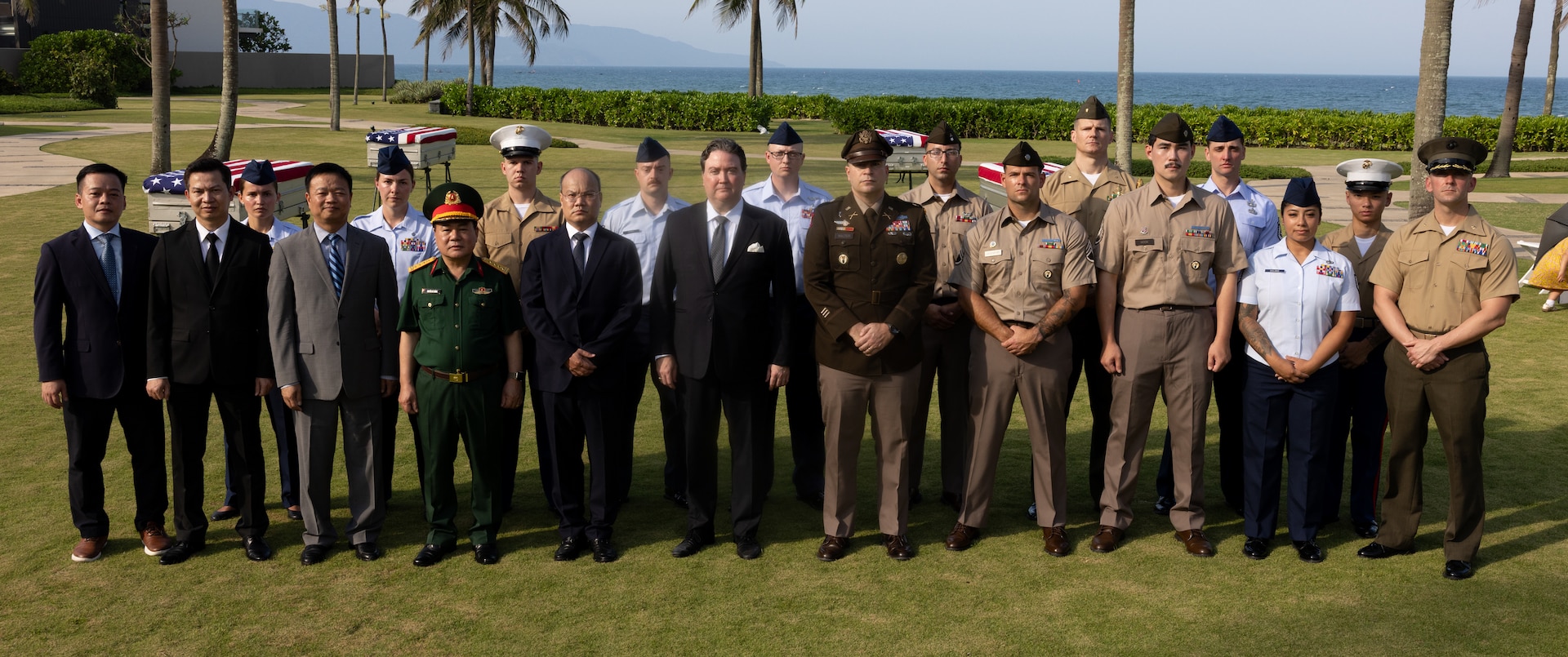 Members of the Defense POW/MIA Accounting Agency repatriation team, members of the Vietnamese Office for Seeking Missing Persons, and U.S. Ambassador Marc Knapper, pose for a photo during a repatriation ceremony in Vietnam, April 19, 2025.
