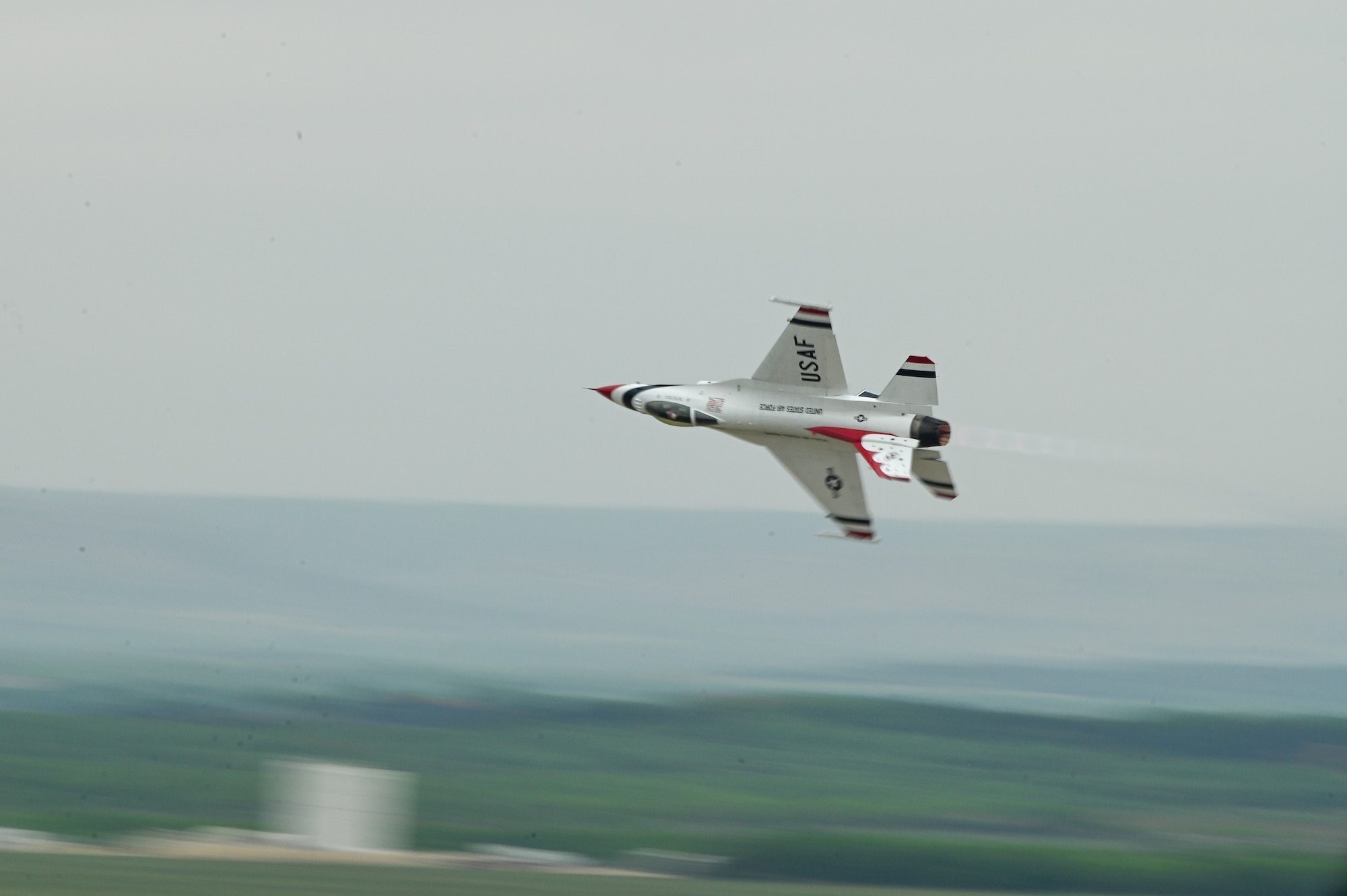 an f-16 flies in the air