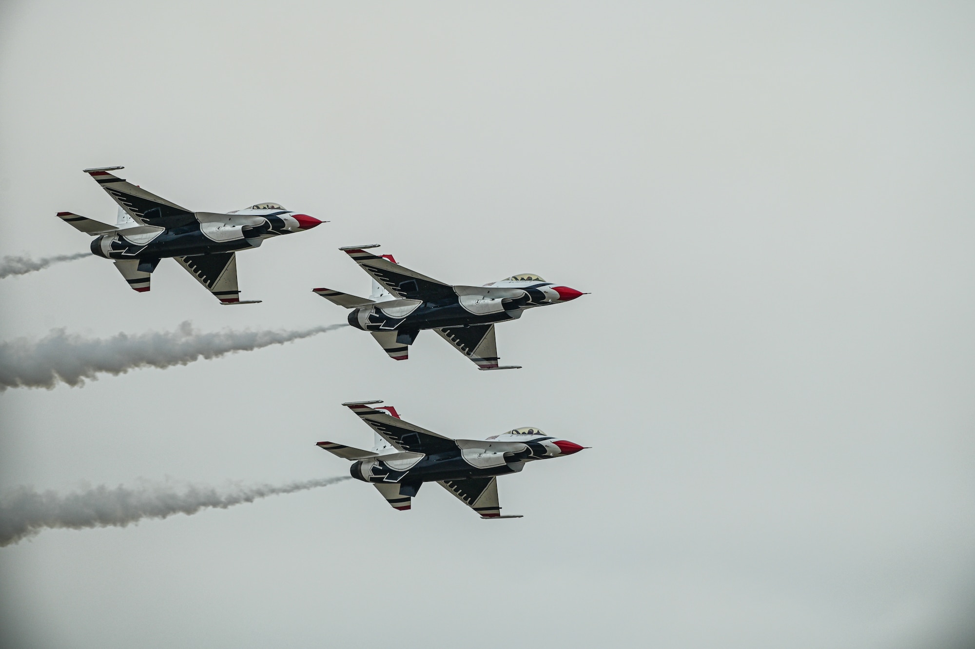 three f-16s fly in close formation