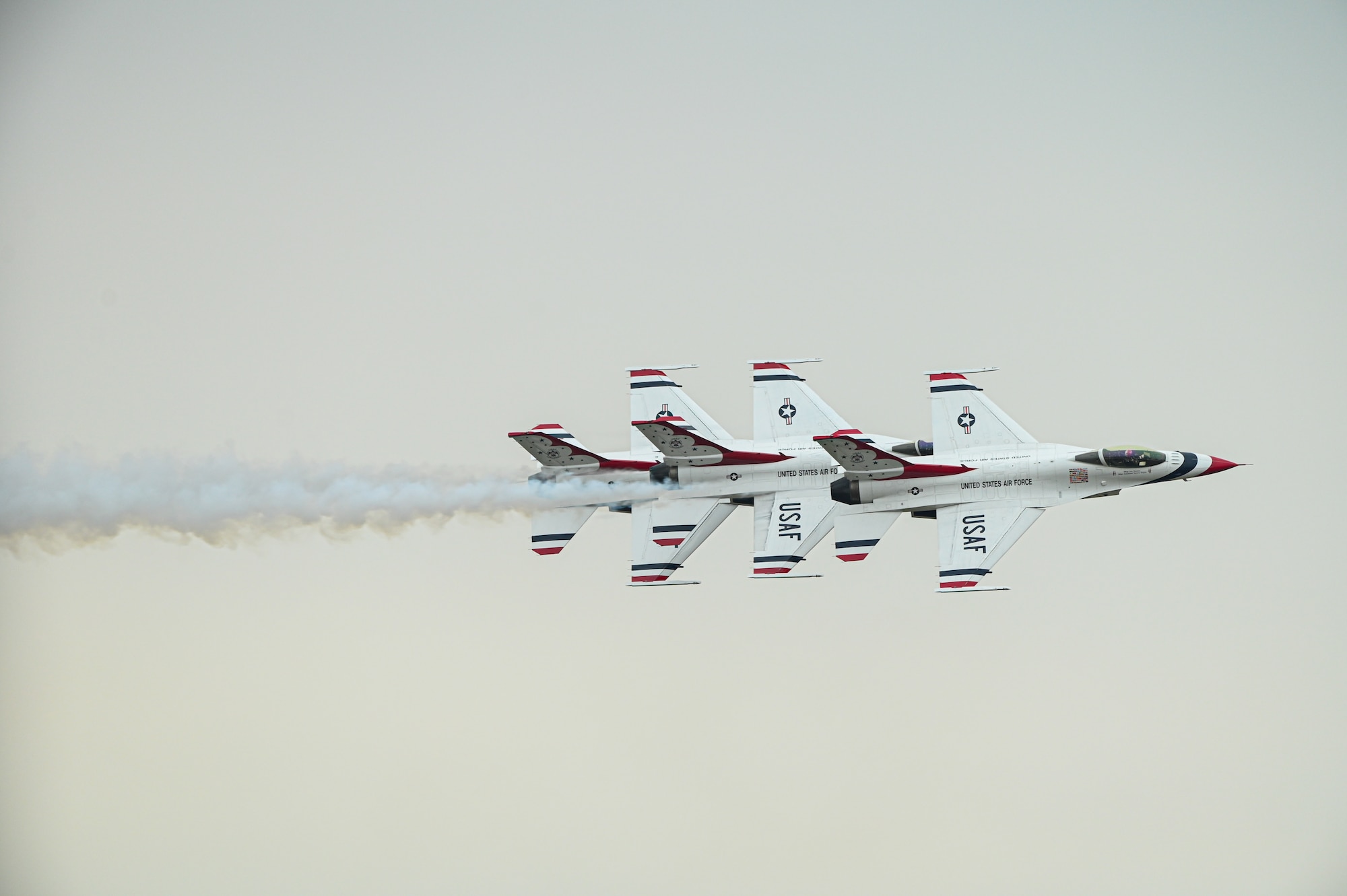 three f-16s fly in close formation