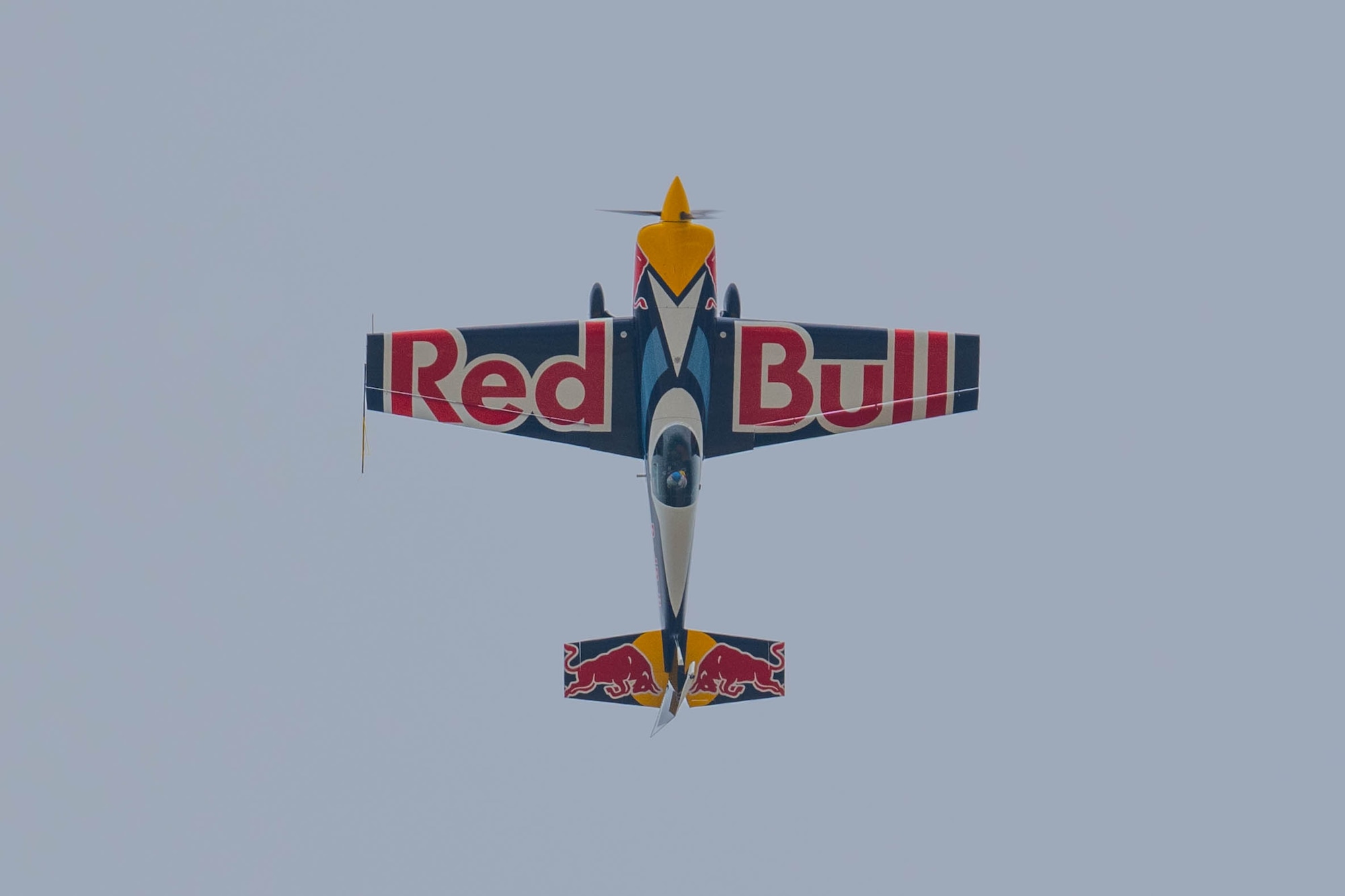 a red bull plane flies in the air
