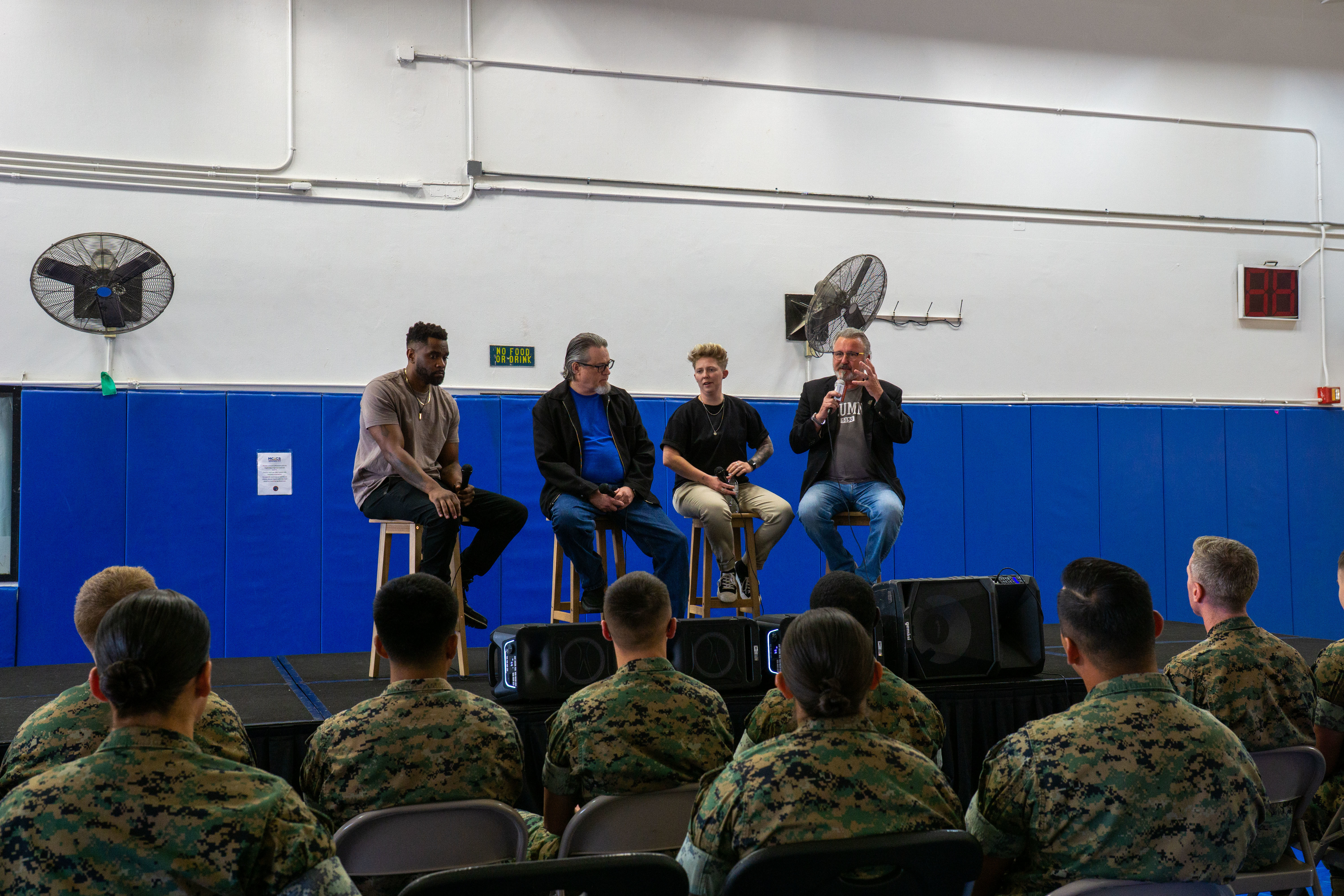 U.S. Marines with Marine Corps Base Camp Blaz listen to 1 Degree of Separation performers at MCB Camp Blaz, Guam, April 11, 2025. U.S. Marines, staff, and visitors attended the comedy show series “1 Degree of Separation” aimed at ending the stigma of mental illness, providing a lighthearted alternative to suicide prevention training. (U.S. Marine Corps photo by Chelsey Suarez-Pierce)