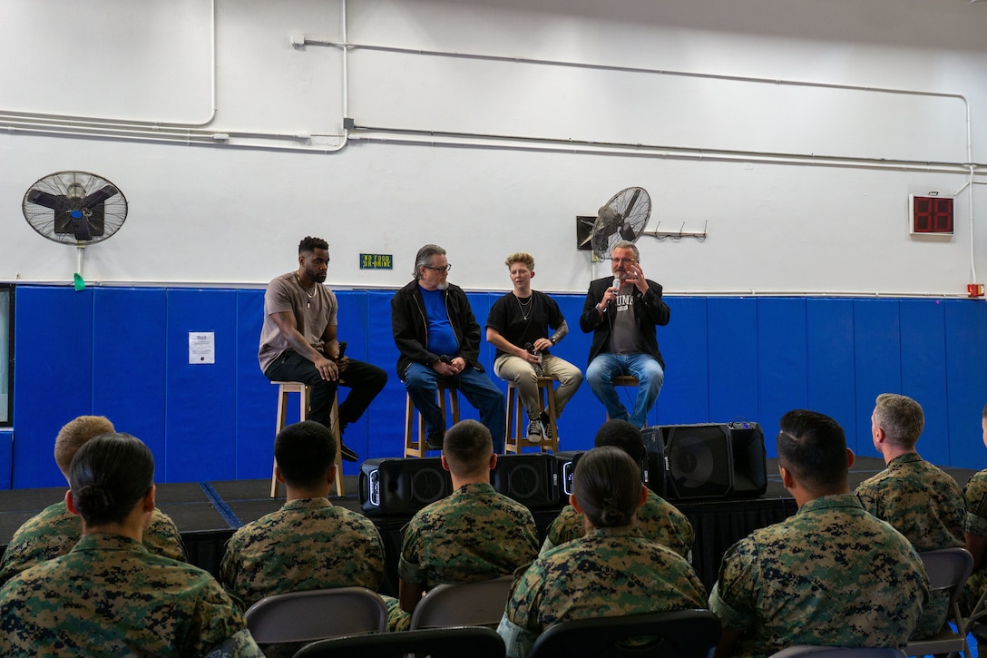 U.S. Marines with Marine Corps Base Camp Blaz listen to 1 Degree of Separation performers at MCB Camp Blaz, Guam, April 11, 2025. U.S. Marines, staff, and visitors attended the comedy show series “1 Degree of Separation” aimed at ending the stigma of mental illness, providing a lighthearted alternative to suicide prevention training. (U.S. Marine Corps photo by Chelsey Suarez-Pierce)