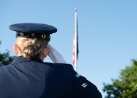 Female Airman saluting the American flag
