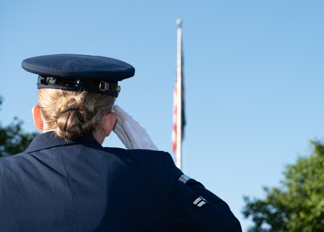 Female Airman saluting the American flag