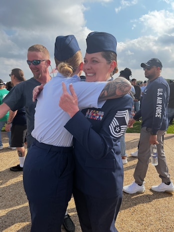 A mother and daughter Airmen hug during a Basic Military Training graduation.