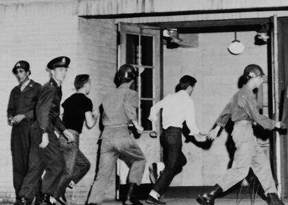 ATLANTA April 27, 1955 - Soldiers of the Georgia National Guard's 122nd Infantry Regiment, 179th Field Artillery Regiment, 48th Signal Company and 878th Engineer Aviation Battalion rush to the Atlanta armory during alert exercise Operation Minuteman.
