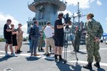 CAIRNS, Australia (April 16, 2025) – Capt. Nicholas DeLeo, commanding officer of the U.S. 7th Fleet flagship USS Blue Ridge (LCC 19), speaks with members of the Australian media on the ship’s flight deck during a scheduled port visit in Cairns, Australia, April 16, 2025. The Blue Ridge and embarked U.S. 7th Fleet staff conduct regular Indo-Pacific patrols to deter aggression, strengthen alliances and partnerships, and advance future warfighting capabilities. (U.S. Navy photo by Mass Communication Specialist Seaman Nicholas Douglass.)
