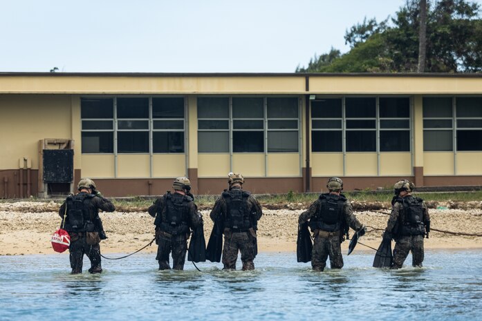 U.S. Marines with 1st Reconnaissance Battalion, 1st Marine Division, resurface after conducting dive operations on Marine Corps Base Hawaii Feb. 24, 2025. 1st Reconnaissance Battalion conducted the training to enhance rapid insertion capabilities in littoral zones as preparation for integrating with 3d Marine Littoral Regiment and its subordinate battalions while forward in the Philippines for Exercise Balikatan 25 and Kamandag 9 this summer. (U.S. Marine Corps photo by Cpl. Malia Sparks)