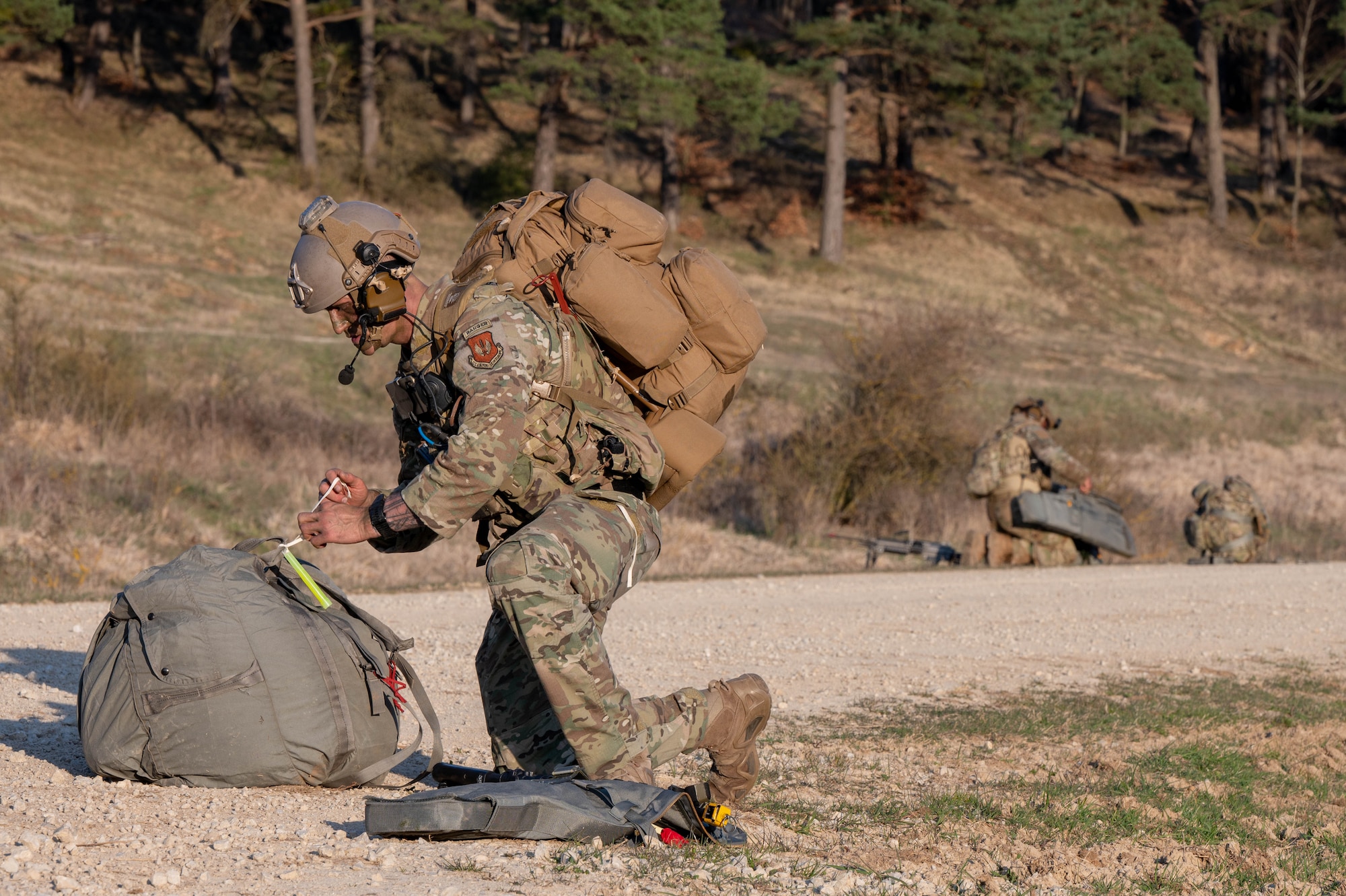 A man gathers his gear after a static-line jump