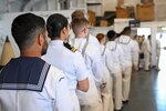 Royal Australian Navy sailors graduate the United States Nuclear Power Training Unit (NPTU) in the hangar bay of USS Yorktown (CV 10), April 18, 2025.