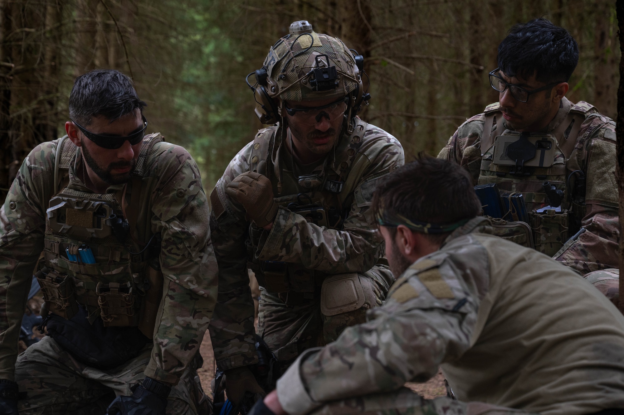 Four men talk after an encounter with opposing forces