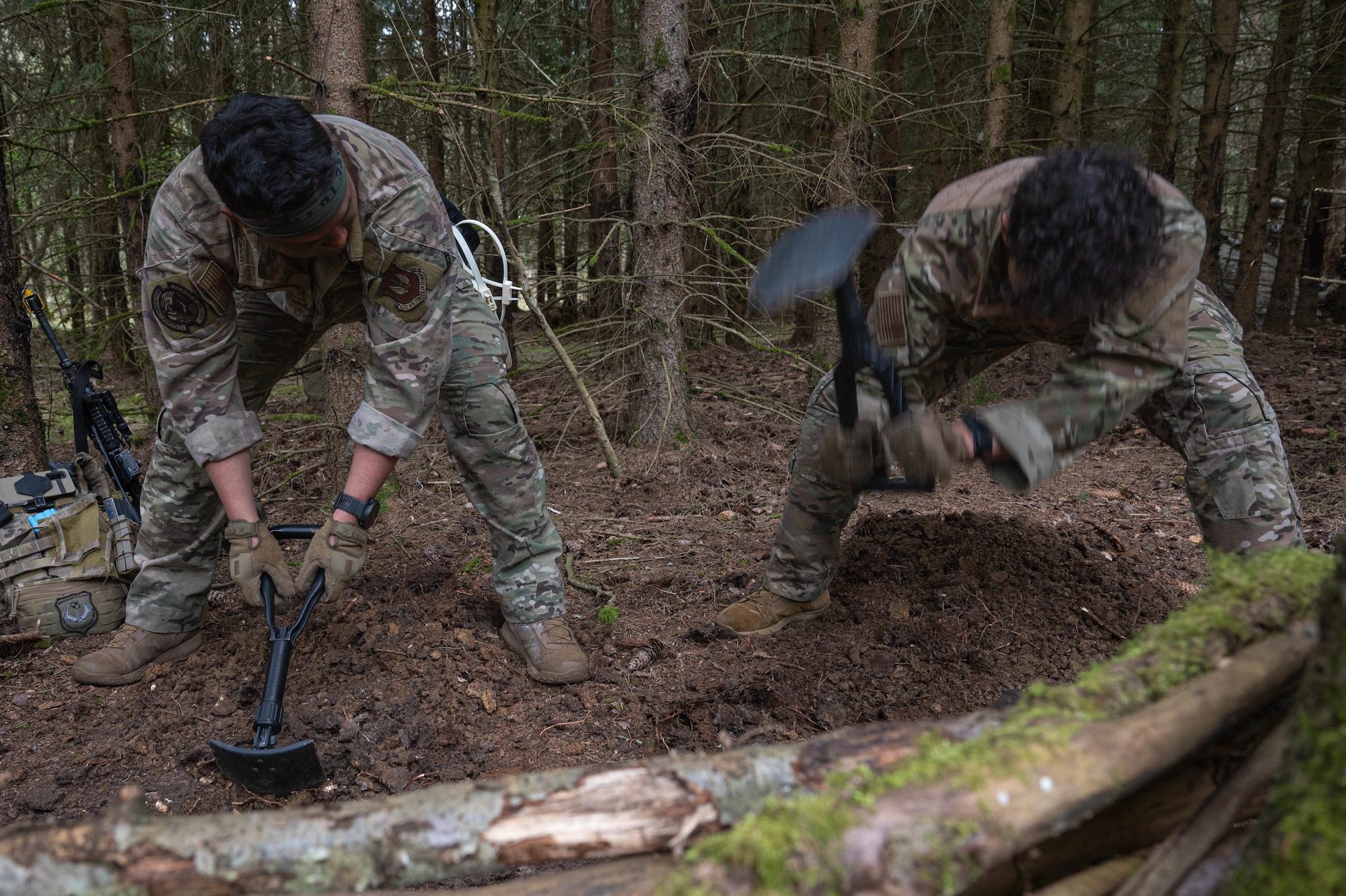 Two men dig at a defensive position