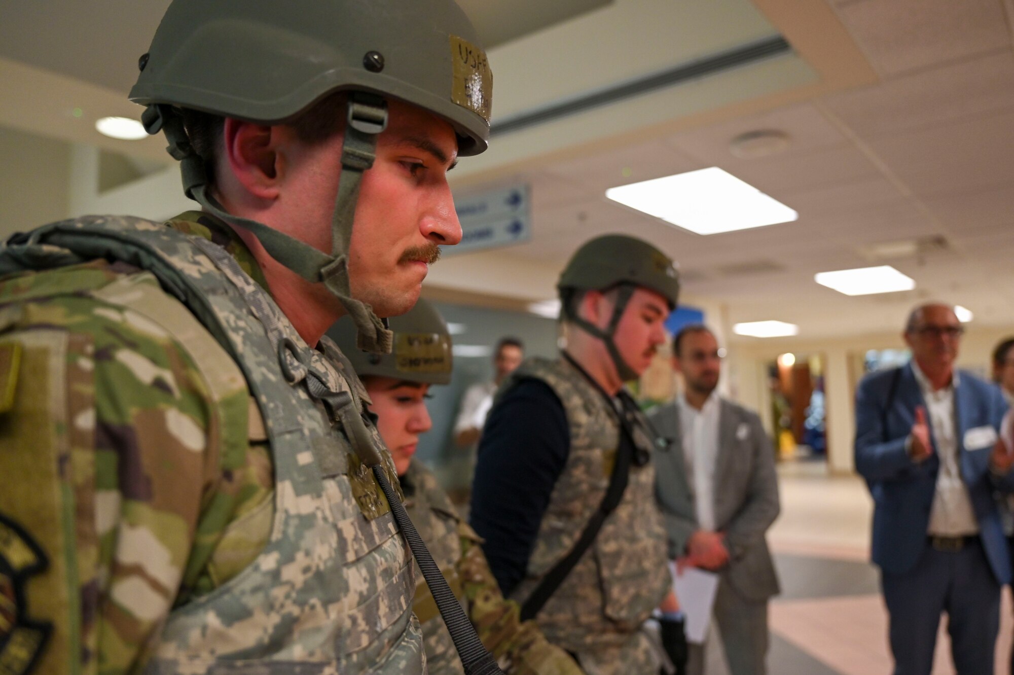 Senior Airman Ethan Oliver carrying a gurney with a training mannequin on it.
