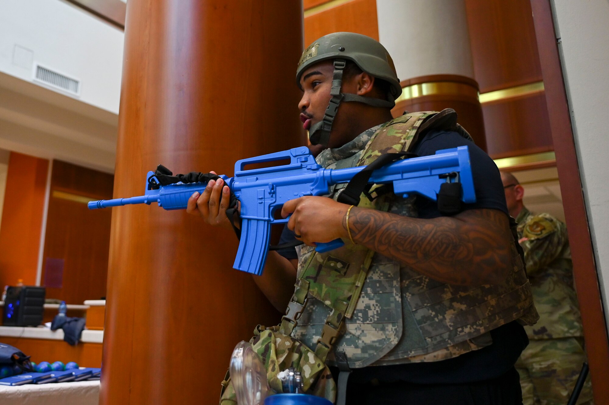 Senior Airman Adrian Nelson holding a training weapon.