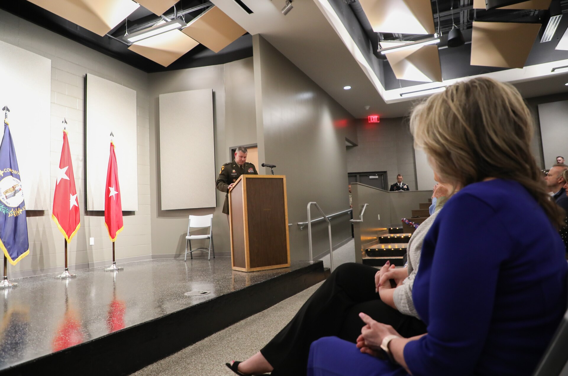 U. S Army Brig. Gen. Ronnie Barnes' wife, Sabrina, looks on as her husband speaks to those in attendance during his promotion ceremony.