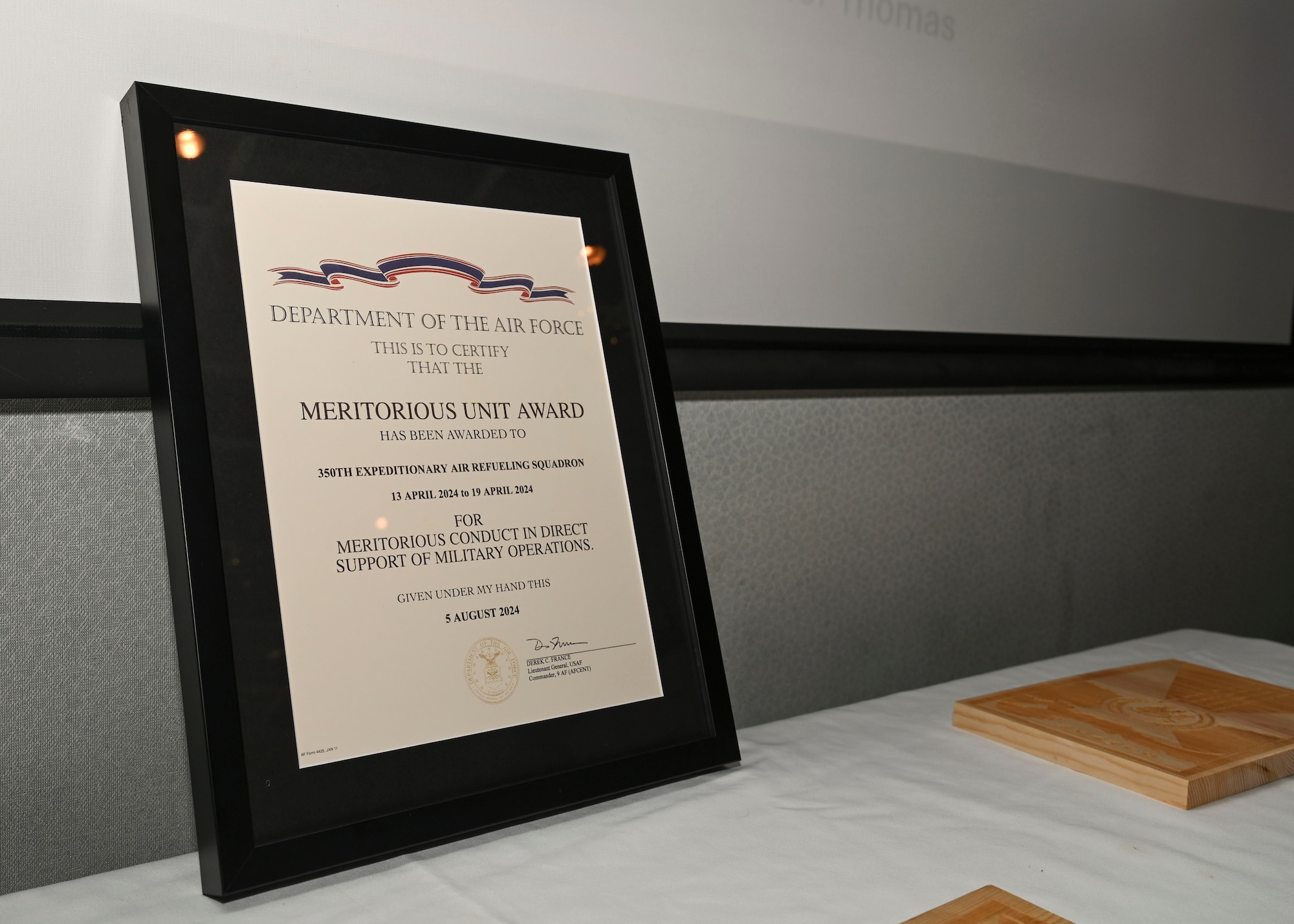 The 350th Expeditionary Air Refueling Squadron’s Meritorious Unit Award is displayed during a ceremony at McConnell Air Force Base, Kansas, April 17, 2025. During the ceremony, the Airmen that earned the award were recognized. (U.S. Air Force photo by Senior Airman Paige Weldon)