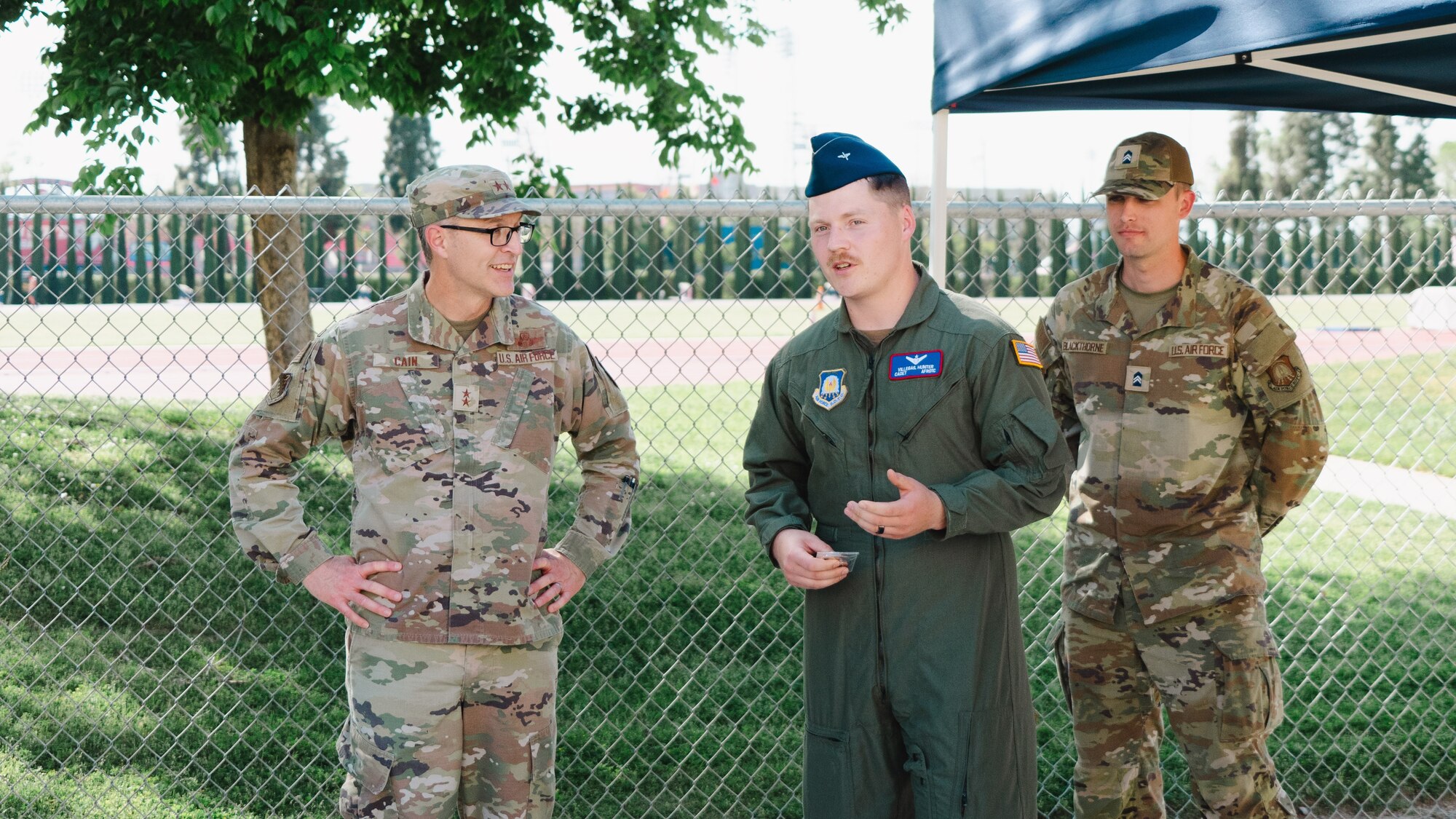 Maj. Gen. Scott A. Cain, AFTC commander, left, has a discussion with cadet Hunter Villegas, Det 035 cadet wing commander. Villegas coined Cain as a thank you to his dedication and commitment to mentoring the future of the force.