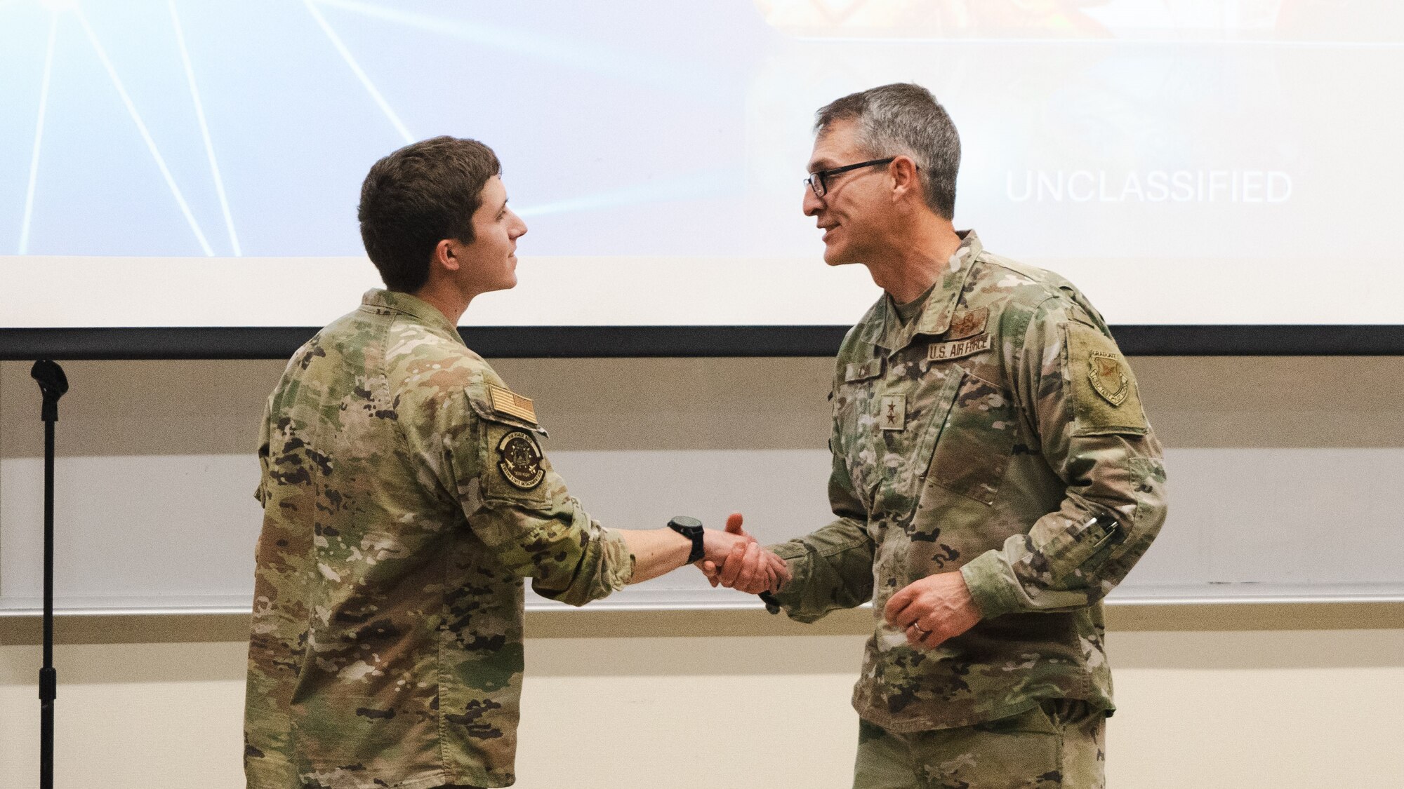 AFROTC Det. 035 cadet Thomas Guenther, left, shakes the hand of Maj. Gen. Scott A. Cain, AFTC commander, April 10 2025. Guenther was one of the many cadets that had the opportunity to meet with Cain and listen in to his leadership brief.