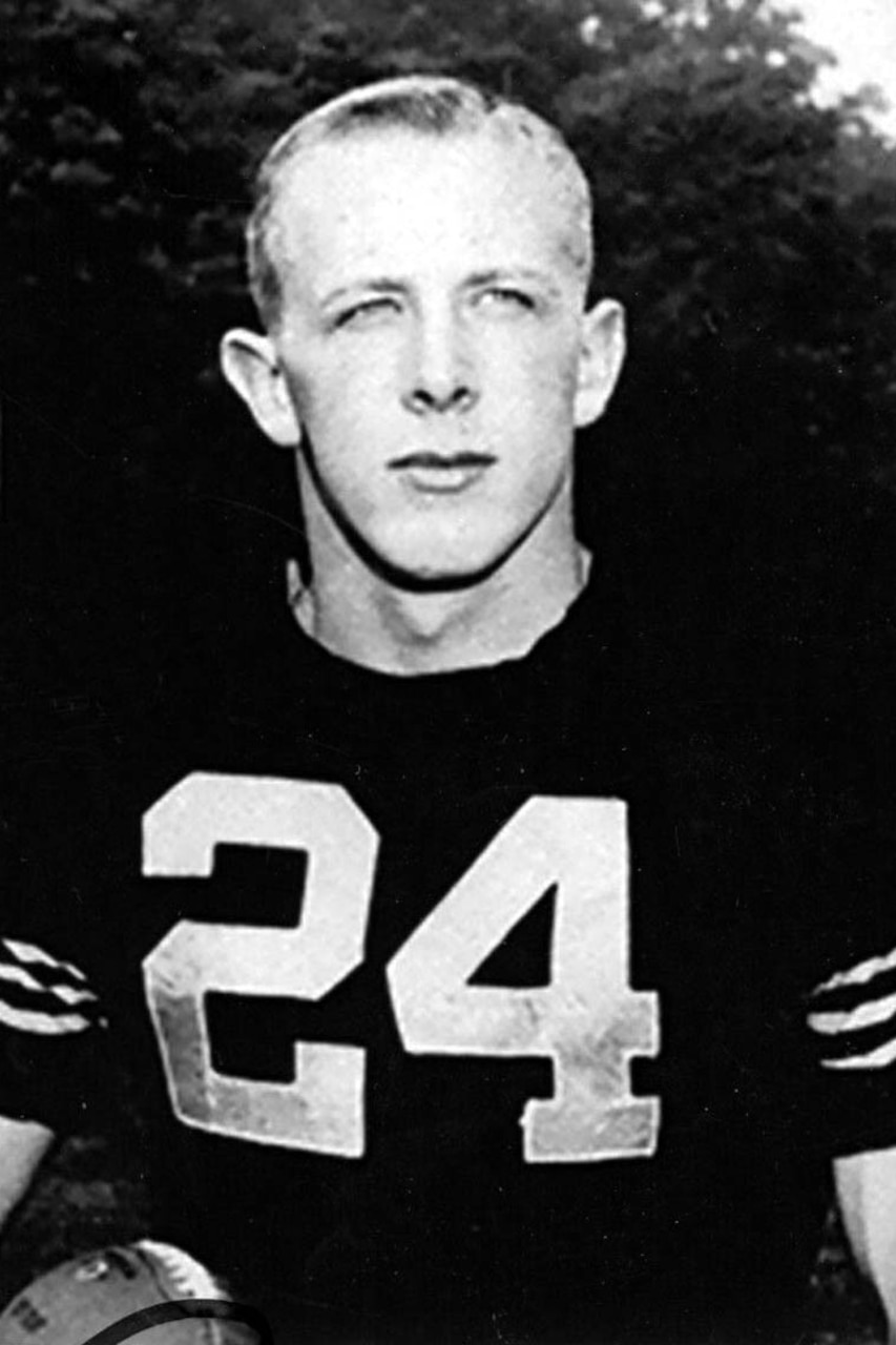 A man in a football uniform with the number 24 on his chest poses for a photo.