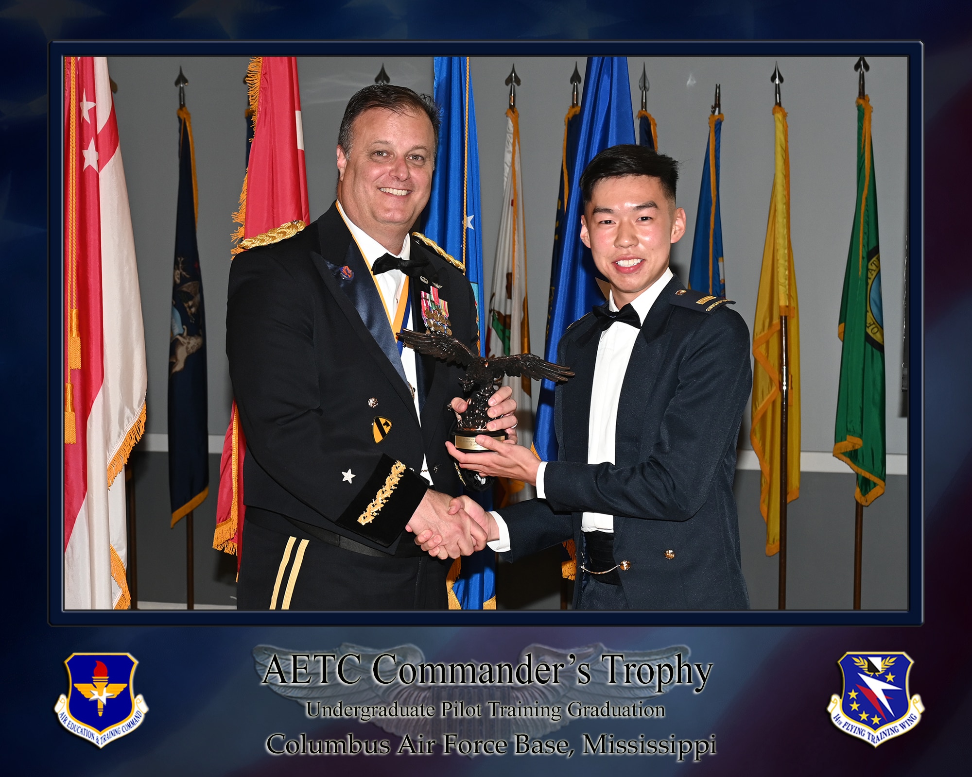 Brigadier General Andrew S. Rendon, and 2d Lt Brandon E. Alcorn, UPT graduate, pose for a photo with the Air Education and Training Command commander’s trophy during a combined graduation ceremony on April 18, 2025, at the Event Center on Columbus Air Force Base, Miss.