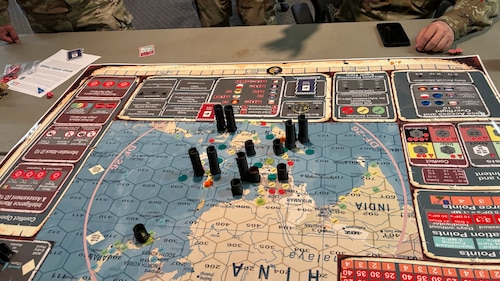 Airmen with the 49th Maintenance Group play Kingfish Ace wargame at Holloman Air Force Base, New Mexico, March 28, 2025. The Kingfish wargame simulates Agile Combat Employment concepts by assigning teams a main operating base with limited logistics, challenging them to overcome obstacles like restricted mobility airlift, shifting international agreements, and unpredictable operational risks. (Courtesy photo)
