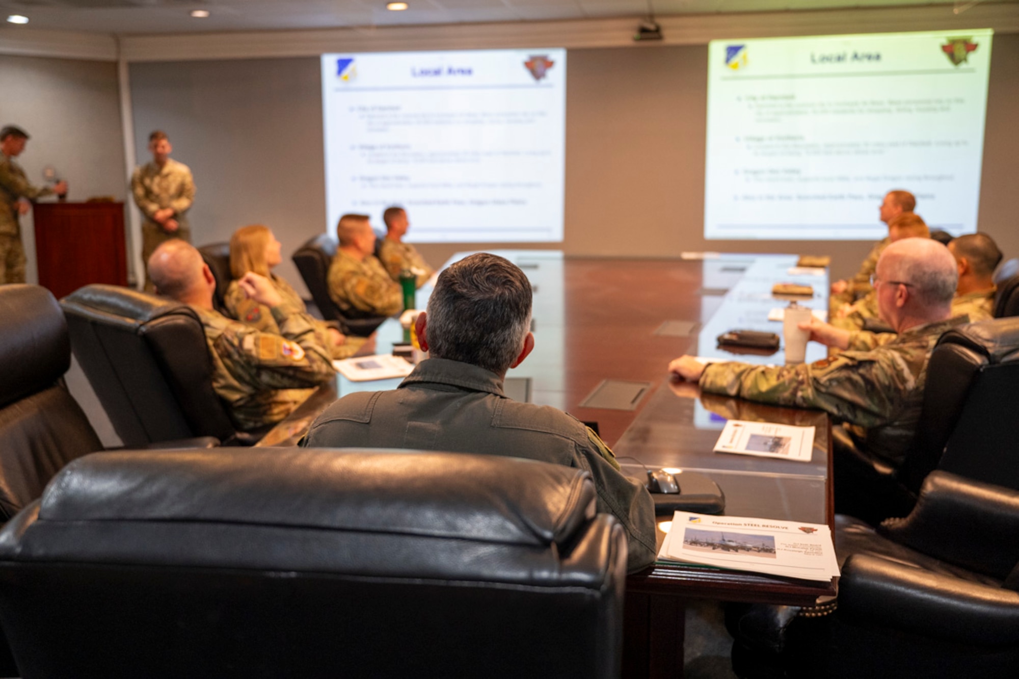 Members of the 49th Maintenance Group conduct a Project Iron Agility deployment exercise brief U.S. Air Force Col. Alfred Rosales, 49th Wing deputy commander, center, at Holloman Air Force Base, New Mexico, March 28, 2025. Project Iron Agility is a three-week deployment exercise focused on preparing Airmen to rapidly adapt to real-world challenges through cross-functional training and mission simulation. (U.S. Air Force photo by Senior Airman Michelle Ferrari)