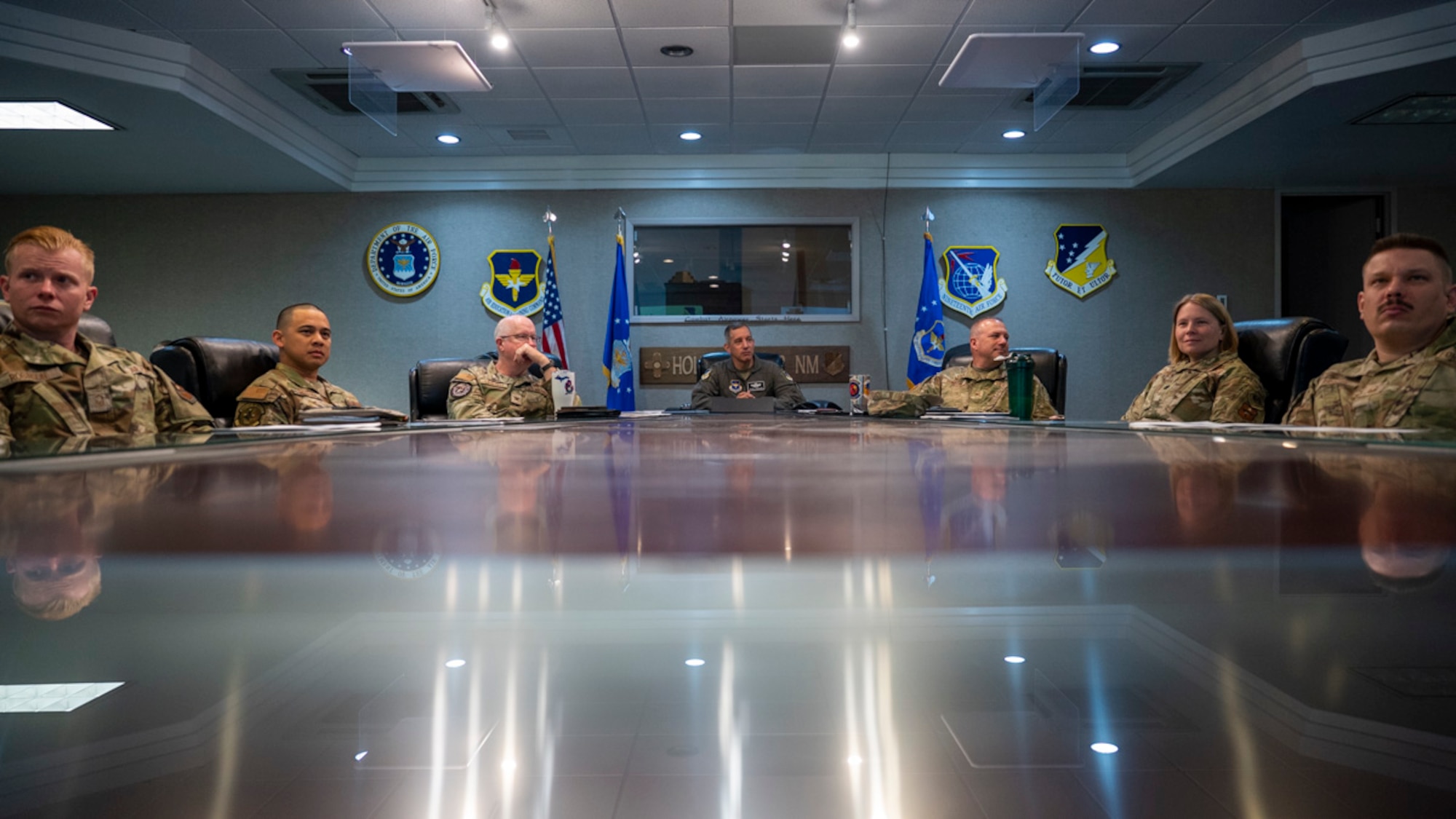 U.S. Air Force Col. Alfred Rosales, 49th Wing deputy commander, center, is briefed on Project Iron Agility at Holloman Air Force Base, New Mexico, March 28, 2025. Project Iron Agility is a three-week deployment exercise focused on preparing Airmen to rapidly adapt to real-world challenges through cross-functional training and mission simulation. (U.S. Air Force photo by Senior Airman Michelle Ferrari)