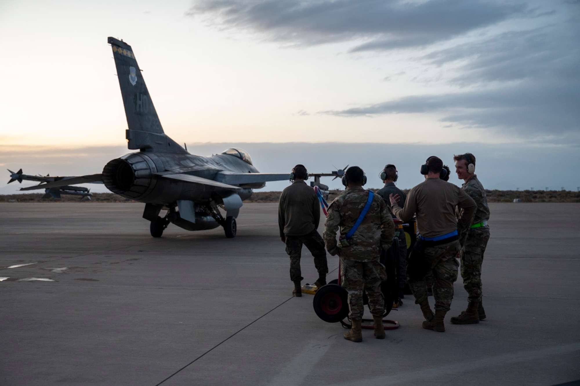 Airmen with the 49th Logistics Readiness Squadron, the 49th Aircraft Maintenance Squadron, and the 849th AMXS prepare an F-16 Fighting Falcon for nighttime operations at Holloman Air Force Base, New Mexico, April 3, 2025. Project Iron Agility brings together logistics, maintenance, and operations personnel in a realistic, multi-phase exercise that tests their ability to sustain combat operations under pressure. (U.S. Air Force photo by Senior Airman Michelle Ferrari)