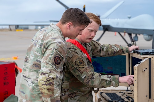 U.S. Air Force 1st Lt. Seth Beard, 49th Component Maintenance Squadron propulsion flight commander, left, and U.S. Air Force Senior Airman Sawyer Noland, 29th Aircraft Maintenance Unit assistant dedicated crew chief, track MQ-9 Reapers for landing at Holloman Air Force Base, New Mexico, April 3, 2025. Aligned with the Agile Combat Employment concept, Project Iron Agility trains Airmen to operate under austere and evolving conditions, emphasizing quick decision-making and decentralized command. (U.S. Air Force photo by Senior Airman Michelle Ferrari)