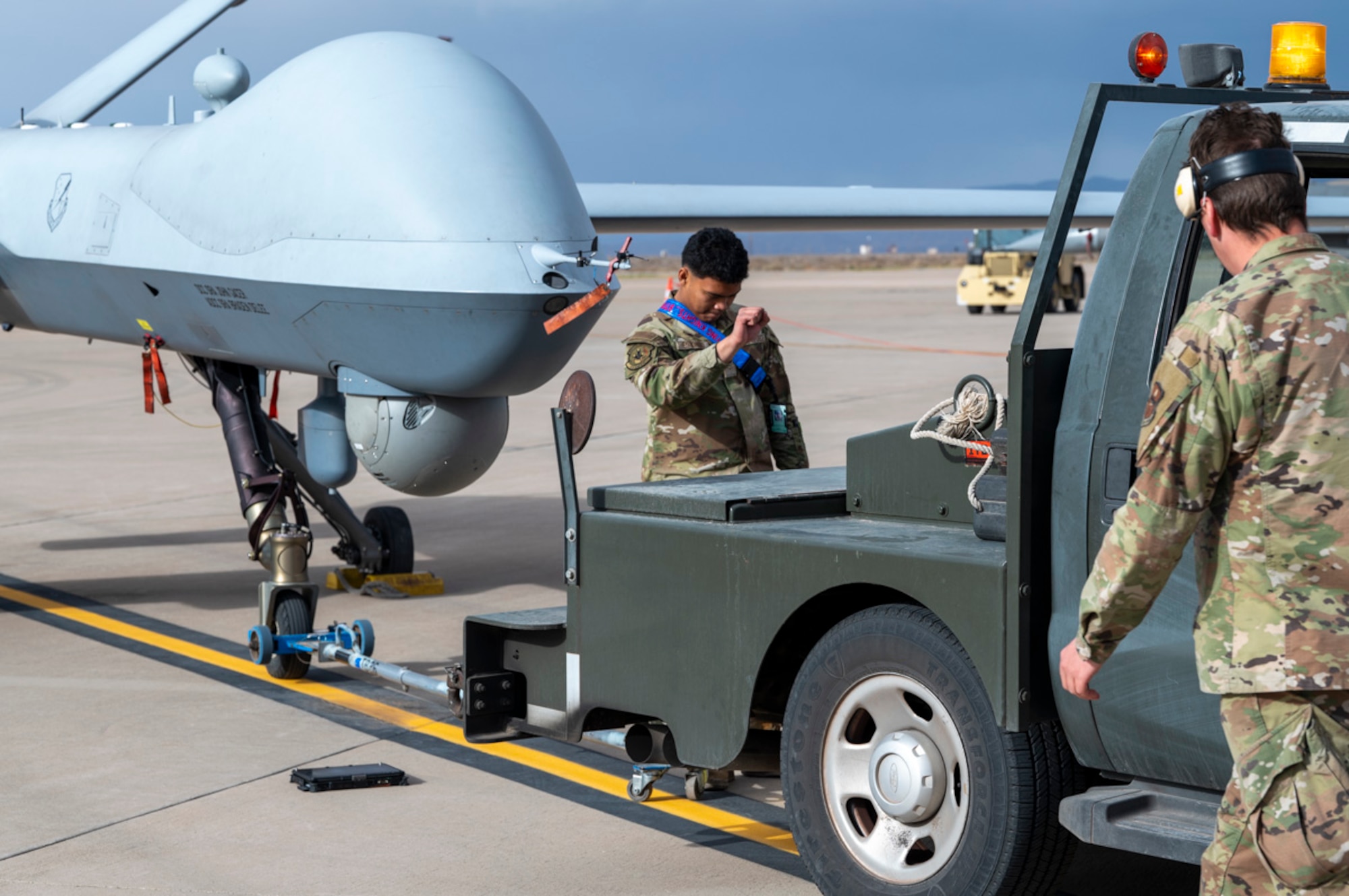 U.S. Air Force Airman Chris Estonido, 49th Aircraft Maintenance Unit MQ-9 aircraft apprentice, prepares an MQ-9 Reaper for towing at Holloman Air Force Base, New Mexico, April 3, 2025. Project Iron Agility brings together logistics, maintenance, and operations personnel in a realistic, multi-phase exercise that tests their ability to sustain combat operations under pressure. (U.S. Air Force photo by Senior Airman Michelle Ferrari)
