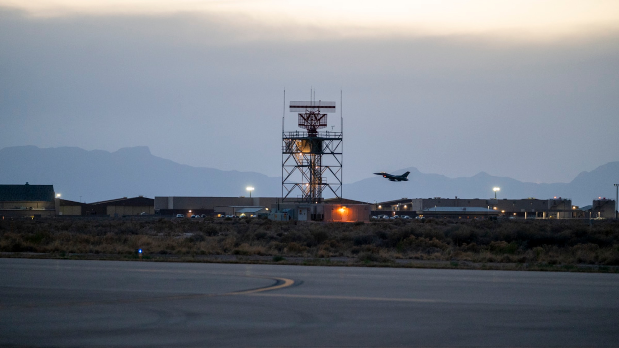An F-16 Fighting Falcon assigned to Holloman Air Force Base, takes off for a nighttime training flight during Project Iron Agility at Holloman Air Force Base, New Mexico, April 3, 2025. Project Iron Agility is a dynamic training exercise designed to sharpen Airmen's deployment readiness skills through agile operations featuring F-16s, MQ-9 Reapers, and integrated logistics support. (U.S. Air Force photo by Senior Airman Michelle Ferrari)