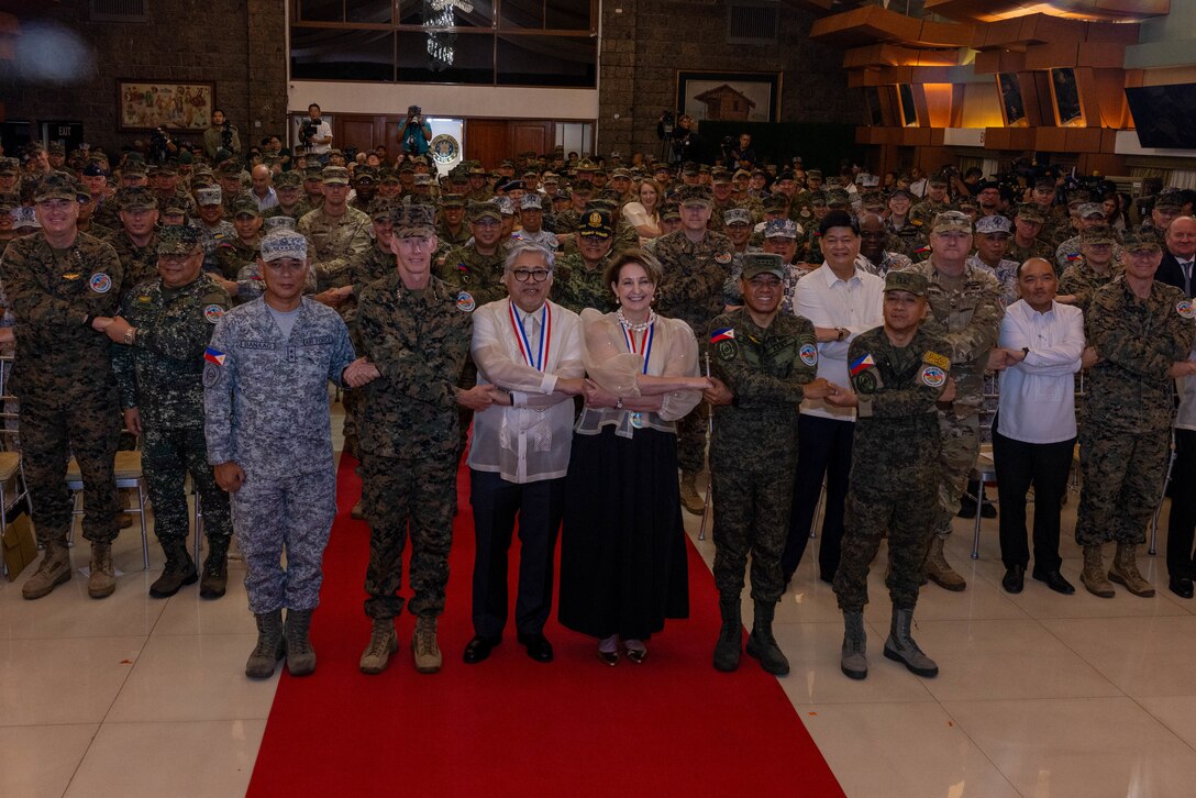 Philippine and U.S. government and military representatives conduct the “crossing of hands” during the opening ceremony to commence Exercise Balikatan 25 at Camp Aguinaldo, Manila, Philippines, April 21, 2025. Balikatan is a longstanding annual exercise between the Armed Forces of the Philippines and the U.S. military designed to strengthen our ironclad alliance, improve our capable combined force and demonstrate our commitment to regional security and stability. (U.S. Marine Corps photo by Lance Cpl. Erica Padgett)