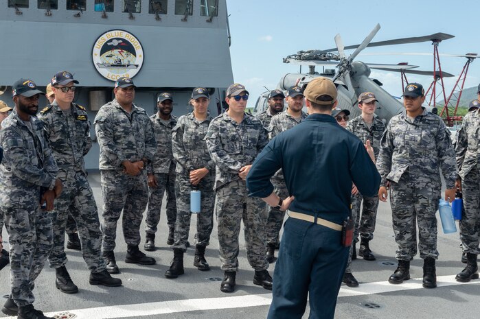 CAIRNS, Australia (April 16, 2025) – Lt. Cmdr. Hunter Van Hook leads cadets enrolled in the Royal Australian Navy Indigenous Development Program on a tour of the U.S. 7th Fleet flagship USS Blue Ridge (LCC 19) during a scheduled port visit in Cairns, Australia, April 16, 2025. The Blue Ridge and embarked U.S. 7th Fleet staff conduct regular Indo-Pacific patrols to deter aggression, strengthen alliances and partnerships, and advance future warfighting capabilities. (U.S. Navy photo by Mass Communication Specialist Seaman Damian Cook)