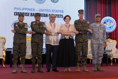Philippine and U.S. government and military representatives conduct the “crossing of hands” during the opening ceremony to commence Exercise Balikatan 25 at Camp Aguinaldo, Manila, Philippines, April 21, 2025.