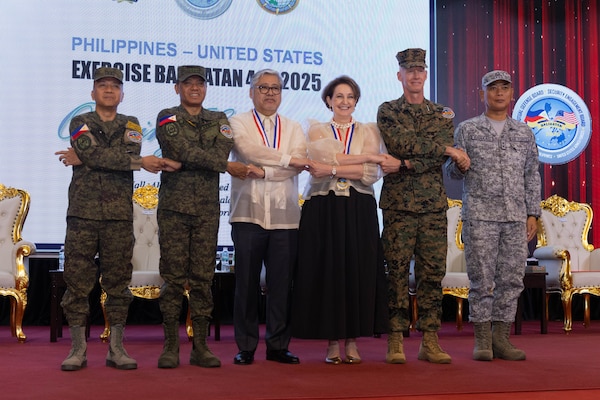 Philippine and U.S. government and military representatives conduct the “crossing of hands” during the opening ceremony to commence Exercise Balikatan 25 at Camp Aguinaldo, Manila, Philippines, April 21, 2025.