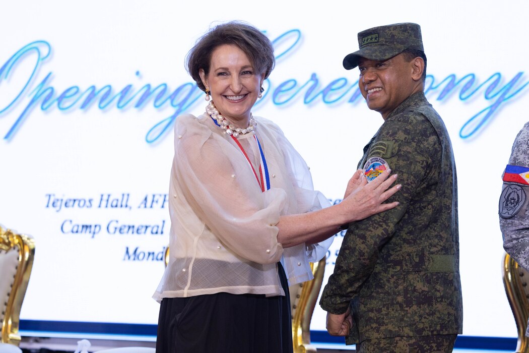 MaryKay Carlson, U.S. Ambassador to the Philippines, places the Balikatan 25 patch on Armed Forces of the Philippines Gen. Romeo S. Brawner Jr., AFP Chief of Staff, during the opening ceremony at Camp Aguinaldo, Manila, Philippines, April 21, 2025.