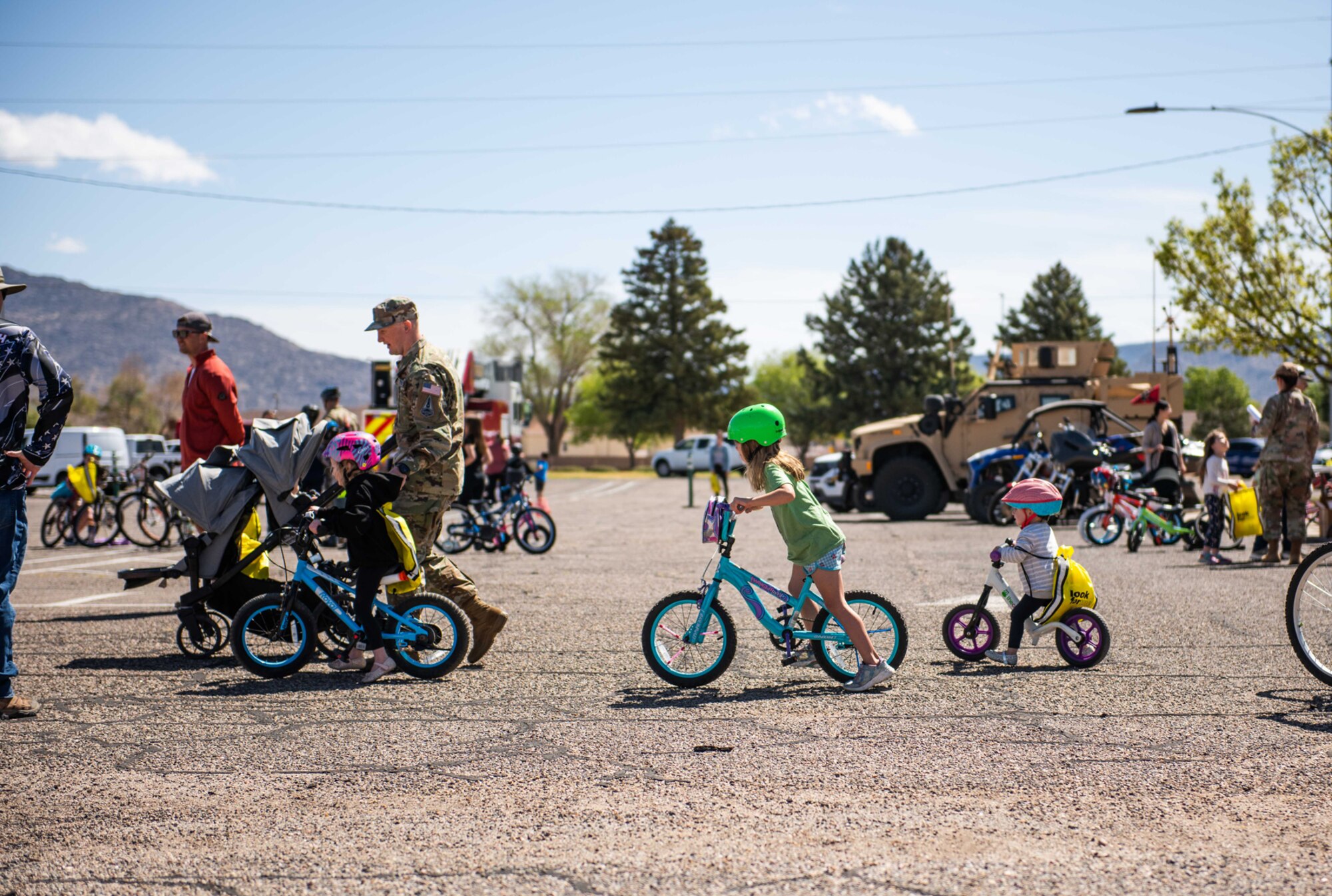 Children on bikes line up for obstacle course