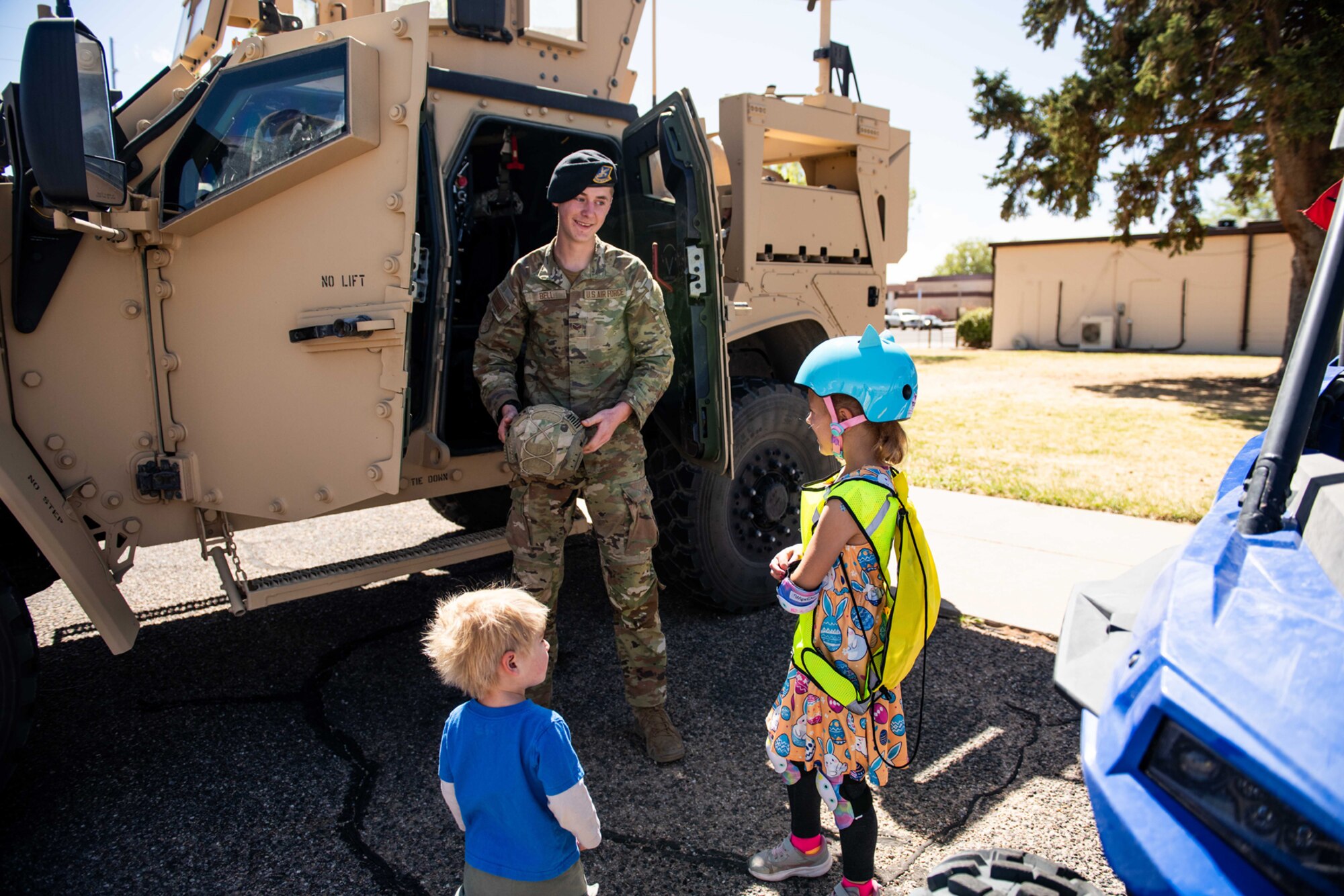 Military member shows kids inside EOD vehicle