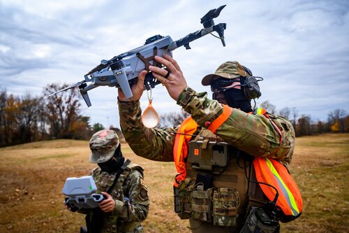 U.S. Air Force Airman 1st Class Ilka Miranda-Miranda, 605th Aircraft Maintenance Squadron administration, and Tech. Sgt. Christopher Anderson, 787 Civil Engineer Squadron engineering section chief, prepare to launch a small unmanned aircraft systems vehicle at Joint Base-McGuire-Dix-Lakehurst, N.J., Nov. 20, 2024. The sUAS program at JB MDL is designed to equip every Airman with basic drone operational training, fostering a deeper understanding of the technology and its potential impact on modern warfare. (U.S. Air Force photo by Senior Airman Matt Porter)