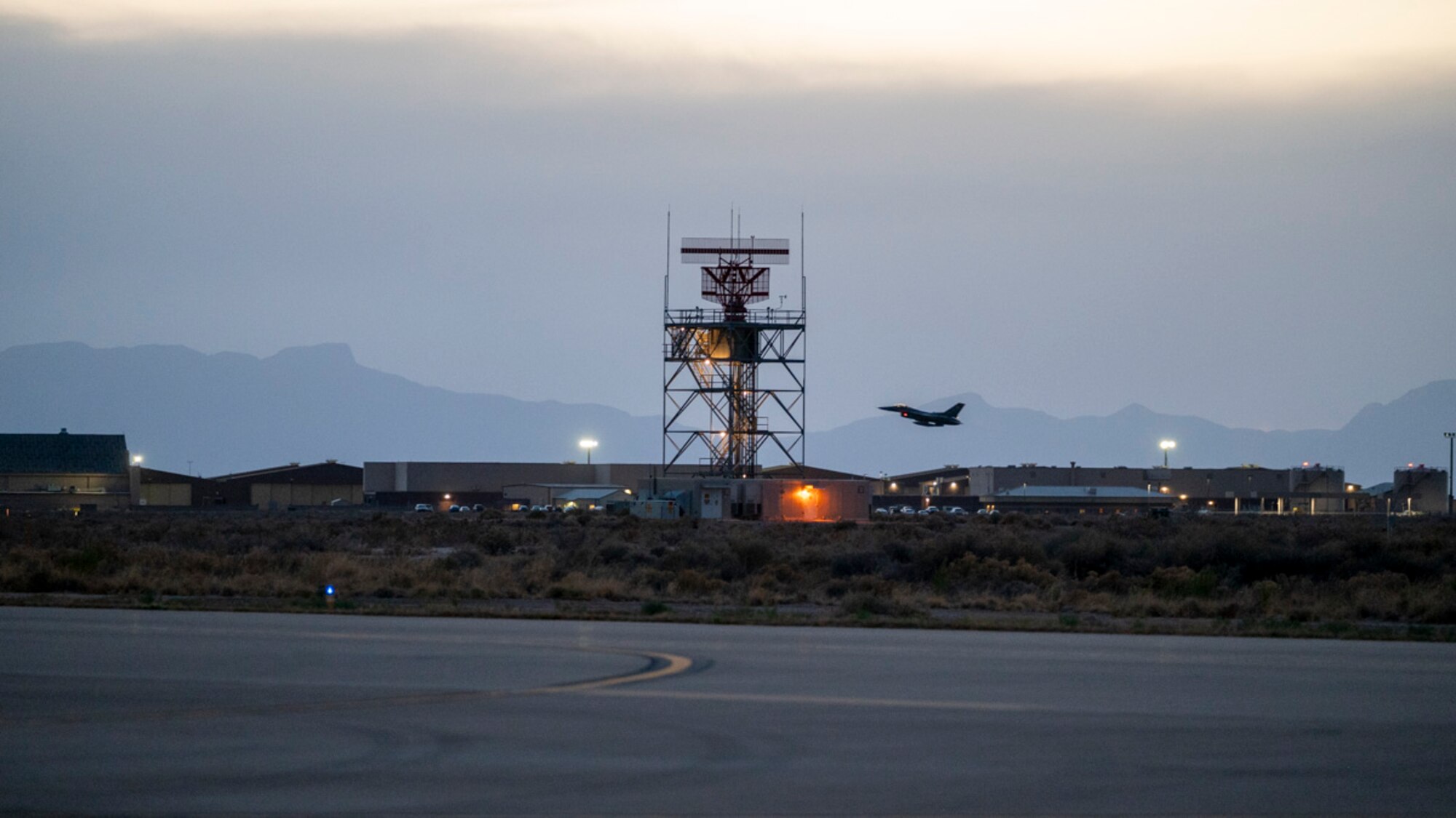 An F-16 Fighting Falcon assigned to Holloman Air Force Base, takes off for a nighttime training flight during Project Iron Agility at Holloman Air Force Base, New Mexico, April 3, 2025. Project Iron Agility is a dynamic training exercise designed to sharpen Airmen's deployment readiness skills through agile operations featuring F-16s, MQ-9 Reapers, and integrated logistics support. (U.S. Air Force photo by Senior Airman Michelle Ferrari)