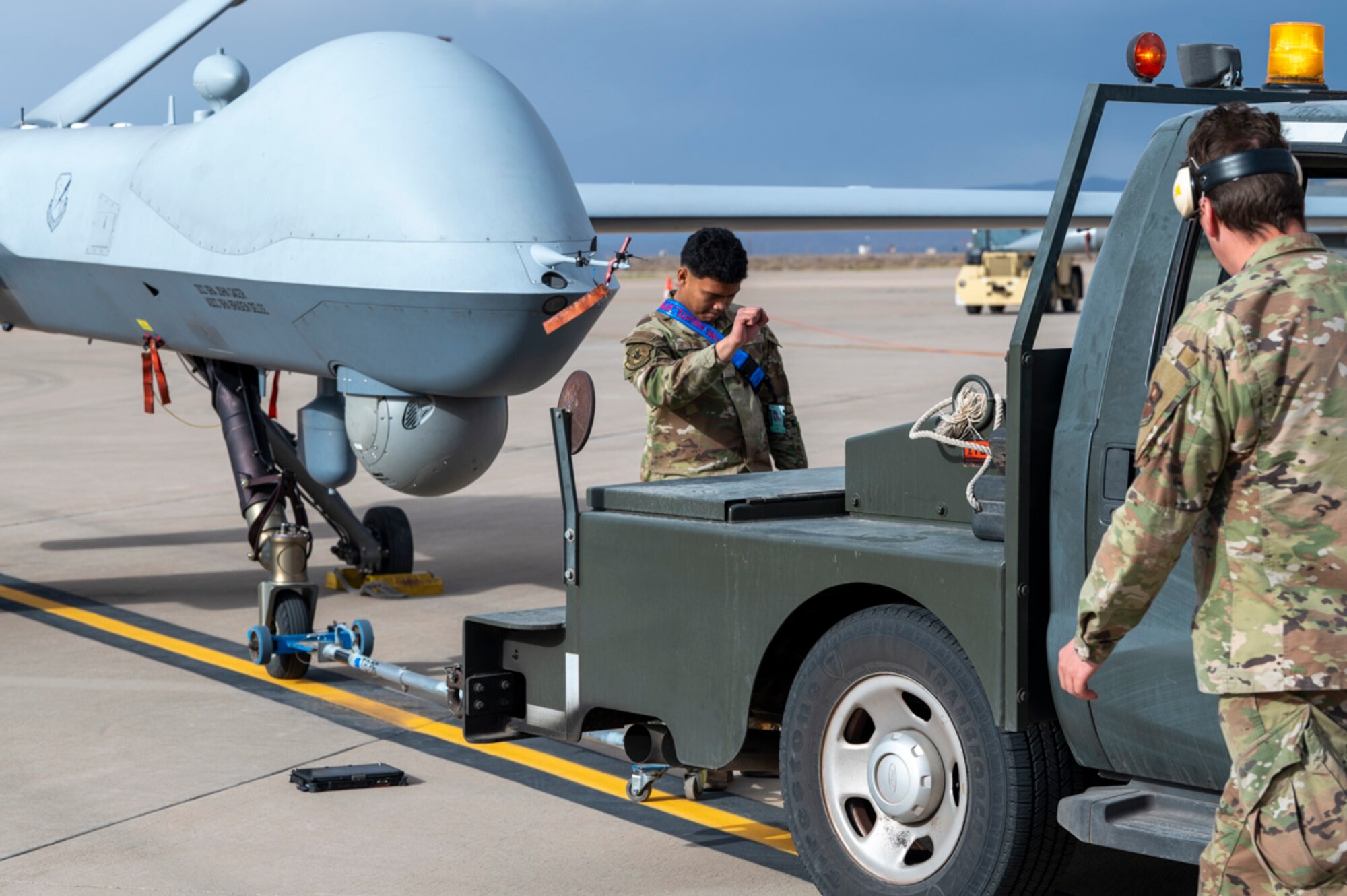U.S. Air Force Airman Chris Estonido, 49th Aircraft Maintenance Unit MQ-9 aircraft apprentice, prepares an MQ-9 Reaper for towing at Holloman Air Force Base, New Mexico, April 3, 2025. Project Iron Agility brings together logistics, maintenance, and operations personnel in a realistic, multi-phase exercise that tests their ability to sustain combat operations under pressure. (U.S. Air Force photo by Senior Airman Michelle Ferrari)