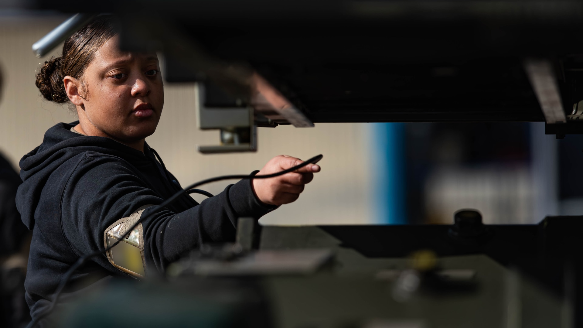 Senior Airman Alaysha Hooks, 23rd Bomber Generation Squadron weapons loader, operates equipment during Exercise Prairie Vigilance 25-1 at Minot Air Force Base, North Dakota, April 12, 2025. These exercises continually develop Airmen, improving their capabilities and increasing mission readiness for a more effective force. (U.S. Air Force photo by Senior Airman Kyle Wilson)