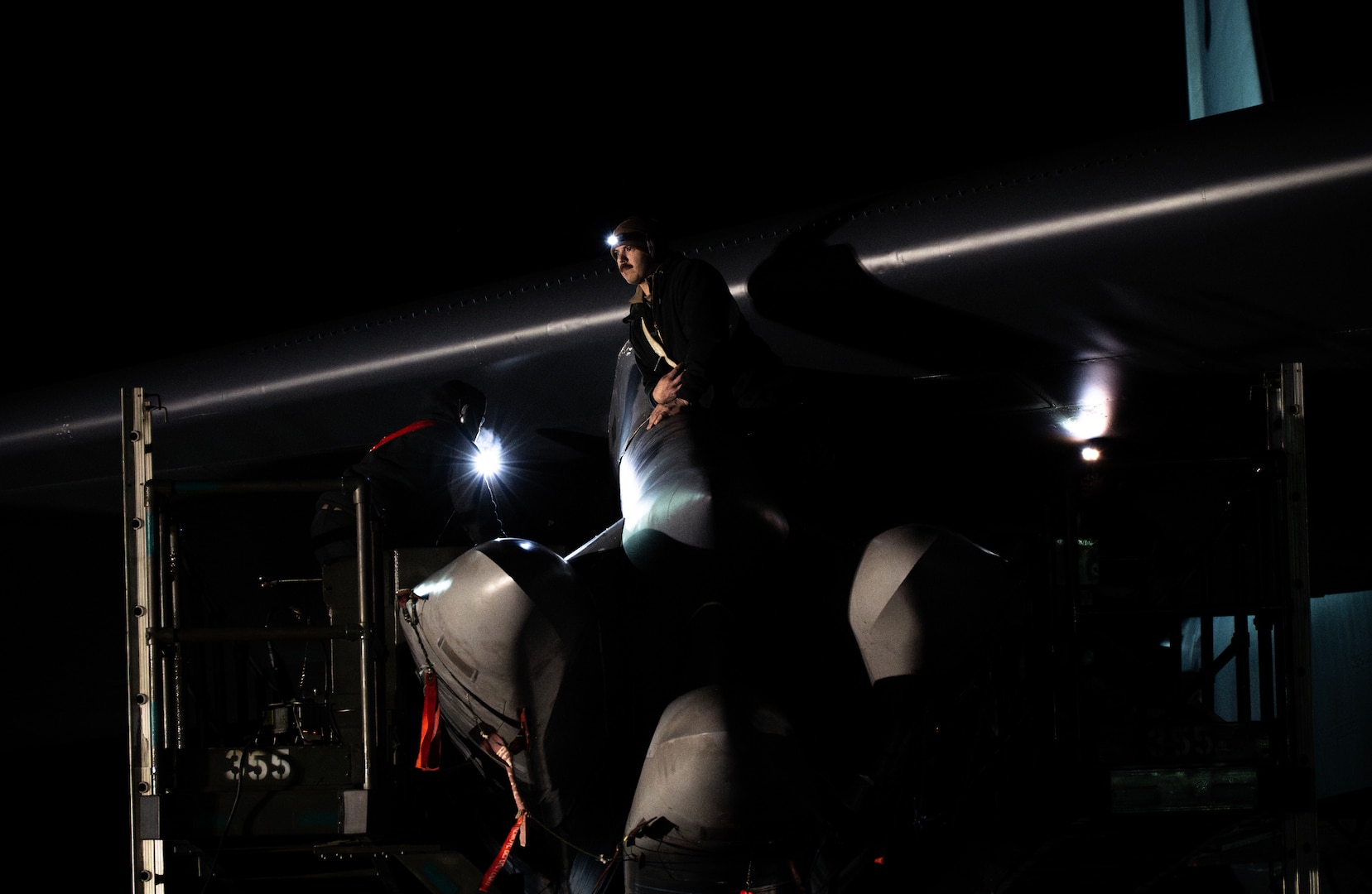 A munitions Airman removes a weapon from a B-52H Stratofortress during Exercise Prairie Vigilance 25-1 at Minot Air Force Base, North Dakota, April 14, 2025. Exercise Prairie Vigilance is a long-standing, preplanned exercise scheduled well in advance of any current world events. The 5th Bomb Wing routinely trains for a variety of scenarios to ensure Air Force Global Strike Command is always prepared and ready to support its combatant commands and the national command authority. (U.S. Air Force photo by Senior Airman Alyssa Bankston)
