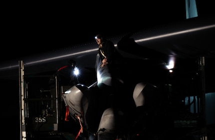 A munitions Airman removes a weapon from a B-52H Stratofortress during Exercise Prairie Vigilance 25-1 at Minot Air Force Base, North Dakota, April 14, 2025. Exercise Prairie Vigilance is a long-standing, preplanned exercise scheduled well in advance of any current world events. The 5th Bomb Wing routinely trains for a variety of scenarios to ensure Air Force Global Strike Command is always prepared and ready to support its combatant commands and the national command authority. (U.S. Air Force photo by Senior Airman Alyssa Bankston)