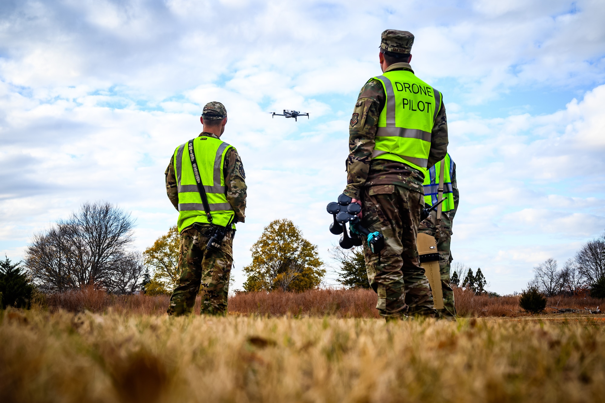 U.S. Air Force Tech. Sgt. Robert Gerry, 87th Civil Engineer Squadron fire protection specialist, U.S. Air Force Master Sgt. Brett Mason, 87th Civil Engineer Group small unmanned aircraft systems program manager, and U.S. Air Force Tech. Sgt. Christopher Anderson, 787 Civil Engineer Squadron engineering section chief, observe a small unmanned aircraft systems vehicle exercise at Joint Base-McGuire-Dix-Lakehurst, N.J., Nov. 20, 2024. The sUAS program at JB MDL is designed to equip every Airman with basic drone operational training, fostering a deeper understanding of the technology and its potential impact on modern warfare. (U.S. Air Force photo by Senior Airman Matt Porter)
