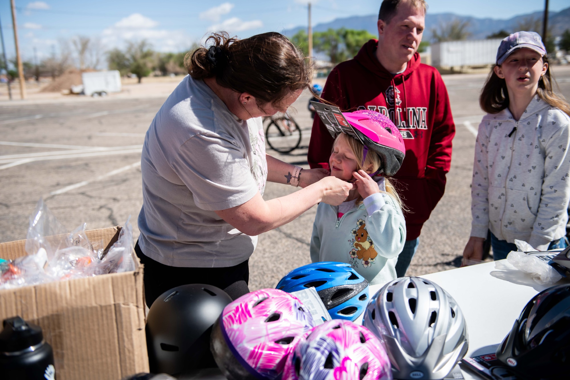 Mom fits new helmet on child