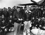 Group of Airman stand next to an aircraft
