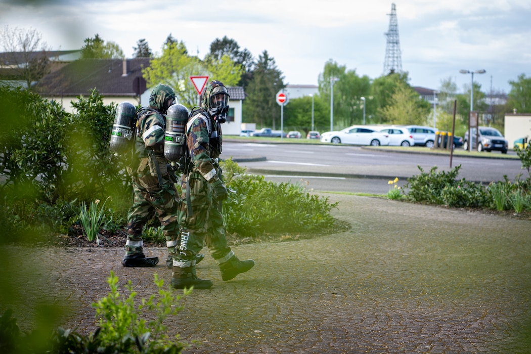 Two individuals walk beside one another looking for a simulated chemical bomb.